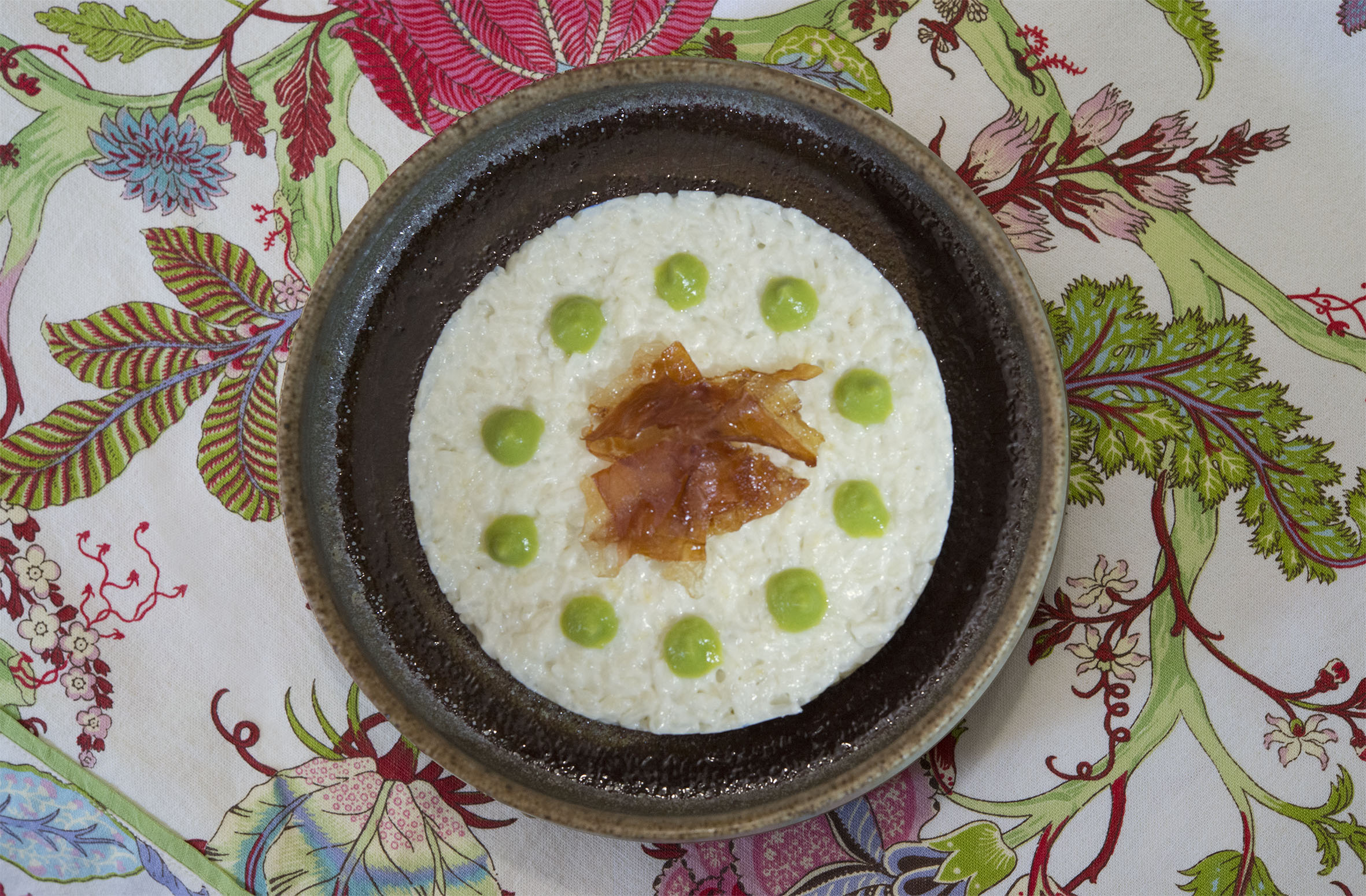 White risotto with crispy speck and green peas sauce